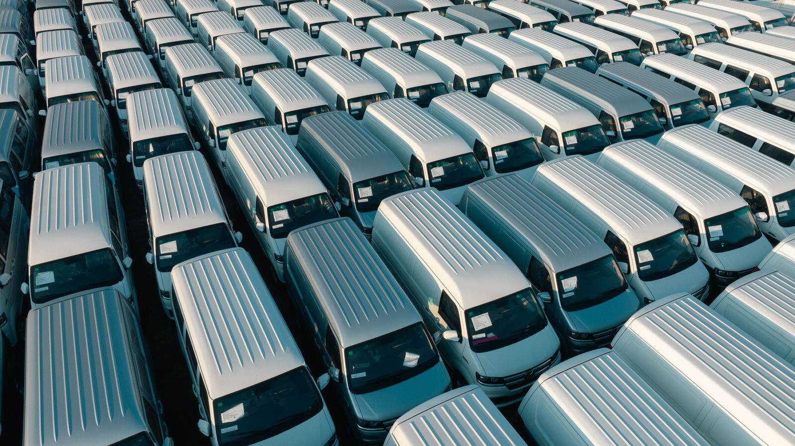 Aerial View of White Vans in Rows in Parking Lot