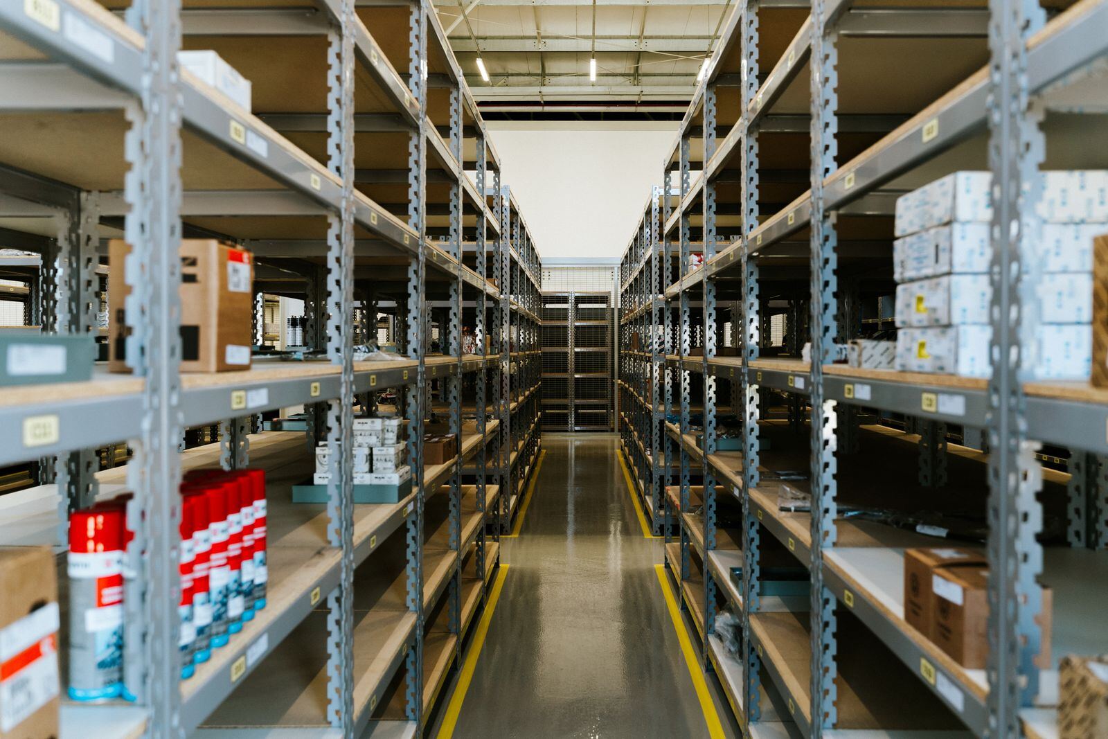 Narrow Walkway Between Metal Shelves